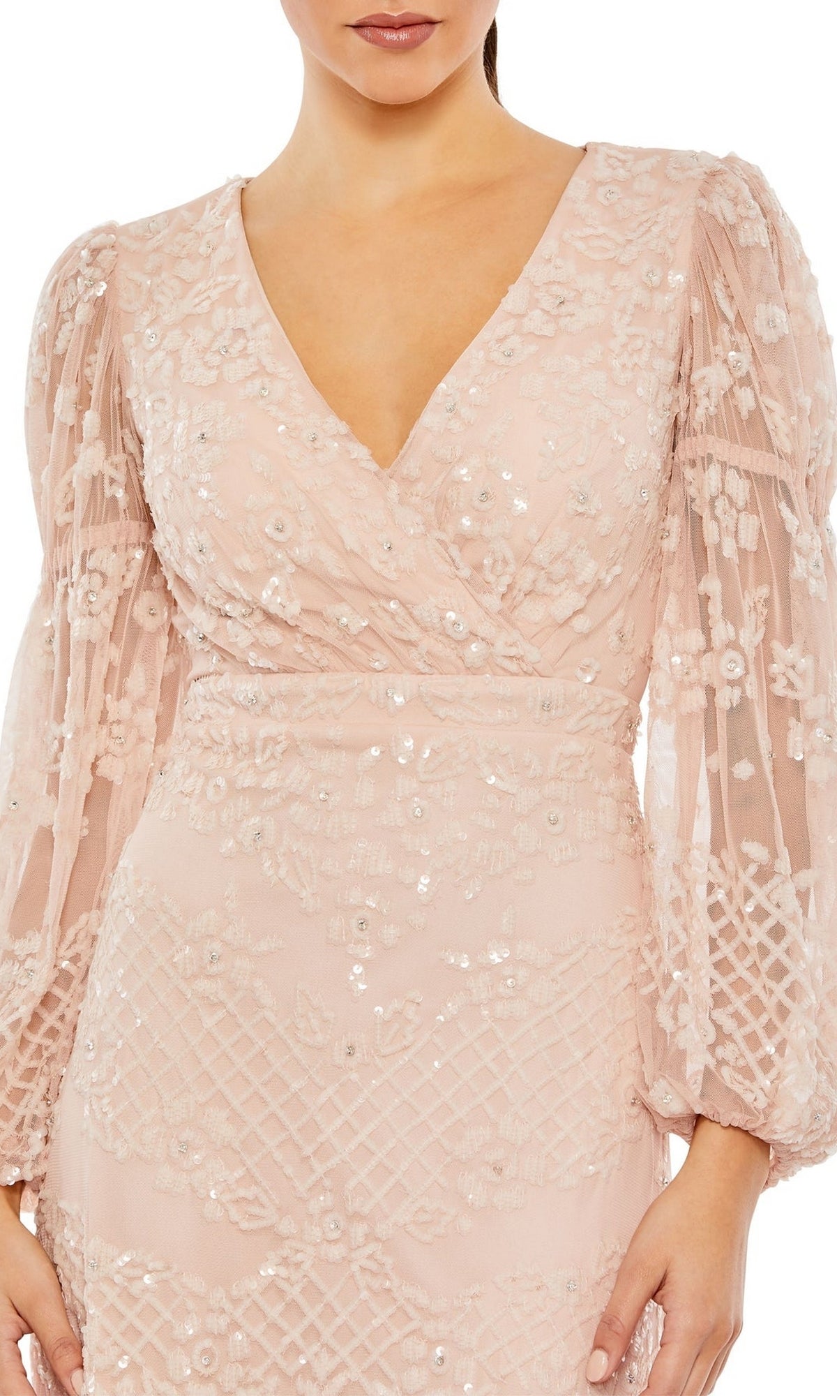 A woman wears the Long Formal Dress 9197 by Mac Duggal, featuring blush pink color, long sleeves, floor-length cut, floral embroidery, sequin details, and a V-neckline.